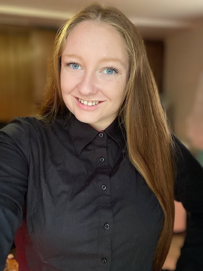 A person in a black shirt smiling at the camera. This is a picture of Emilee, the owner of Events Bar by Emilee in Farnham, Virginia.